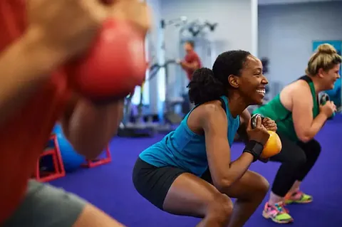 Women exercising with kettleballs